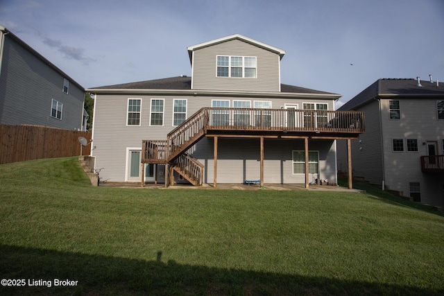 rear view of house with a yard and a deck