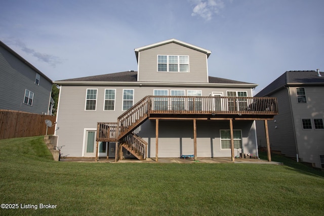 back of property with a wooden deck, a yard, and a patio area