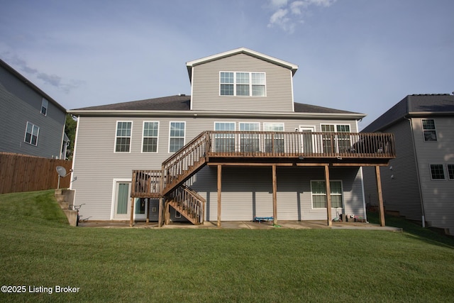 back of house with a wooden deck, a yard, and a patio area