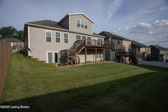 back of house with a yard and a deck