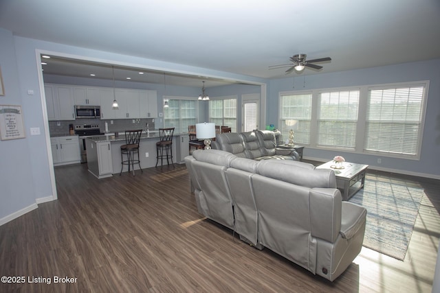 living room with ceiling fan and dark hardwood / wood-style floors