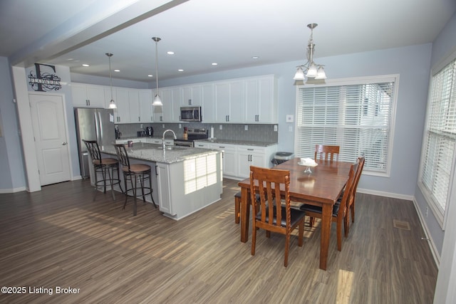 dining space with sink and dark hardwood / wood-style flooring