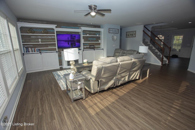 living room featuring dark hardwood / wood-style floors and ceiling fan