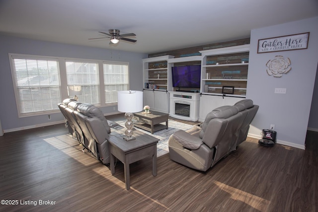 living room featuring ceiling fan and dark hardwood / wood-style flooring