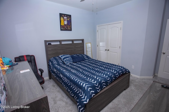 carpeted bedroom featuring a closet and ceiling fan