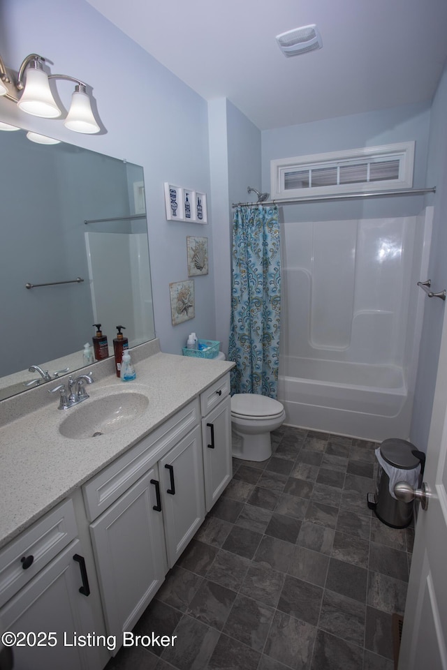 full bathroom with shower / tub combo with curtain, vanity, and toilet