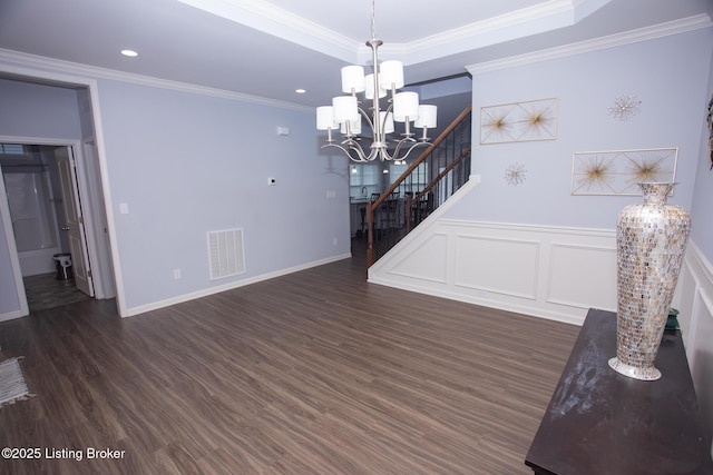 interior space with an inviting chandelier, crown molding, and dark hardwood / wood-style floors