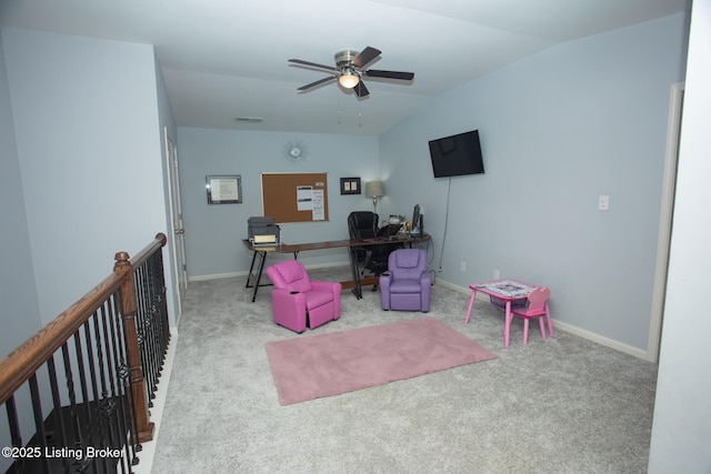 office space featuring vaulted ceiling, light colored carpet, and ceiling fan