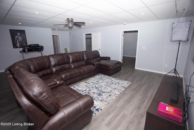 living room featuring ceiling fan and hardwood / wood-style floors