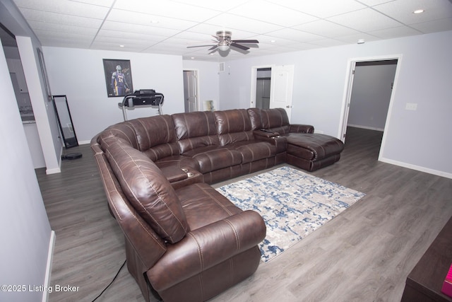 living room featuring wood-type flooring and ceiling fan