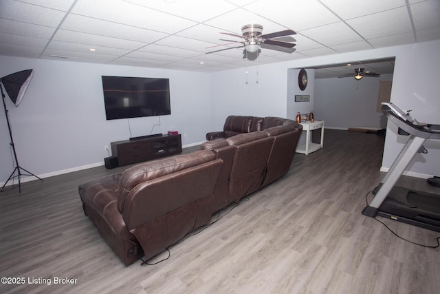 living room with ceiling fan, a paneled ceiling, and hardwood / wood-style floors