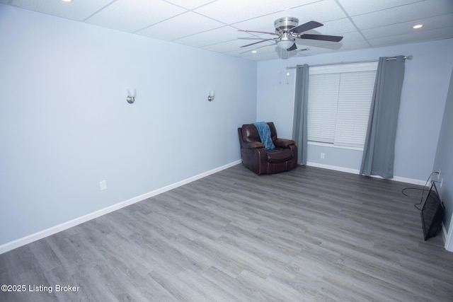 unfurnished room featuring ceiling fan, a paneled ceiling, and hardwood / wood-style floors