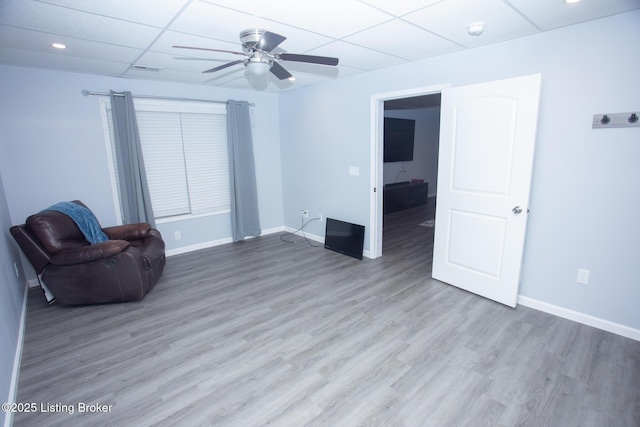 unfurnished room with wood-type flooring, a paneled ceiling, and ceiling fan