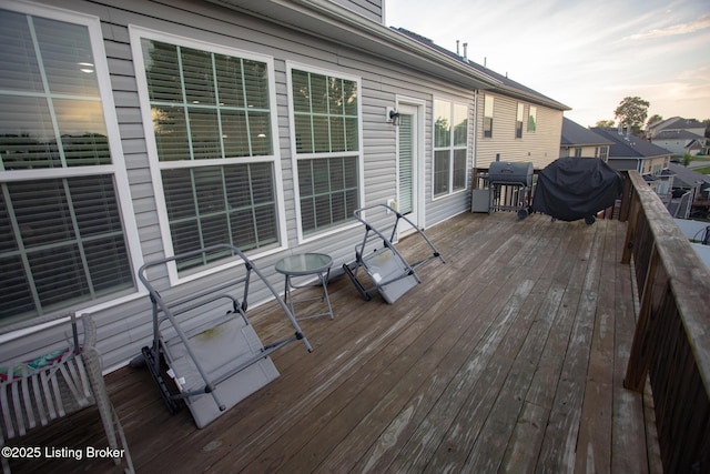 deck at dusk featuring area for grilling