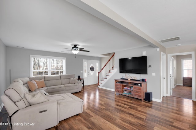 living room featuring ceiling fan and hardwood / wood-style floors