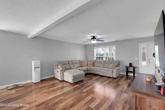 living room featuring beamed ceiling, dark hardwood / wood-style floors, a textured ceiling, and ceiling fan