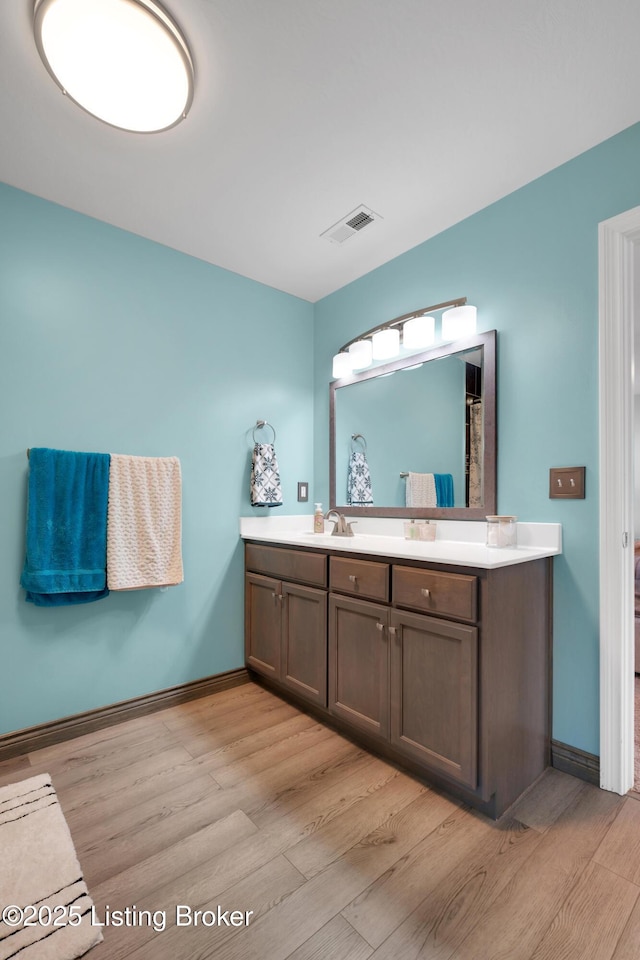 bathroom with wood-type flooring and vanity