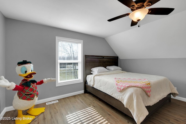 bedroom with vaulted ceiling, hardwood / wood-style floors, and ceiling fan