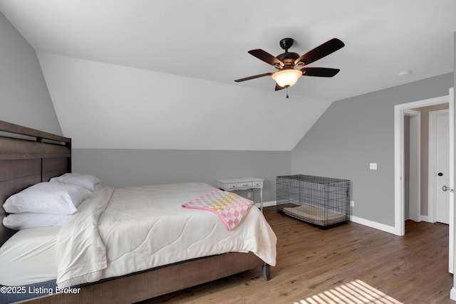 bedroom with lofted ceiling, hardwood / wood-style floors, and ceiling fan