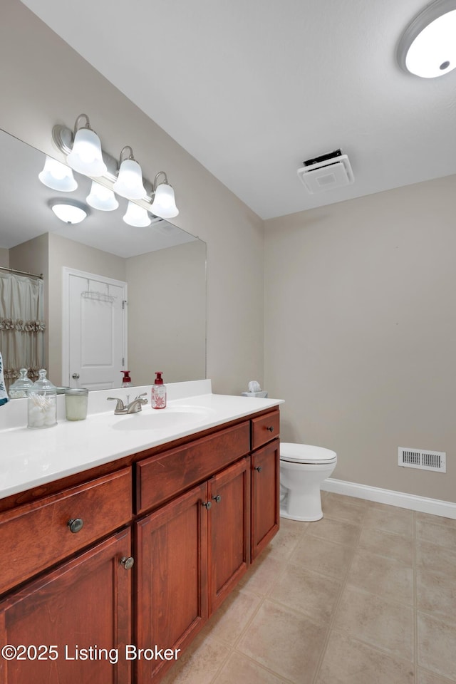 bathroom with vanity, tile patterned flooring, and toilet