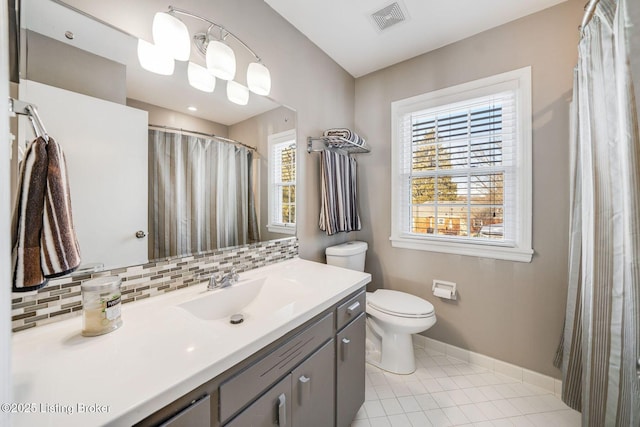 bathroom featuring tile patterned floors, vanity, toilet, and decorative backsplash