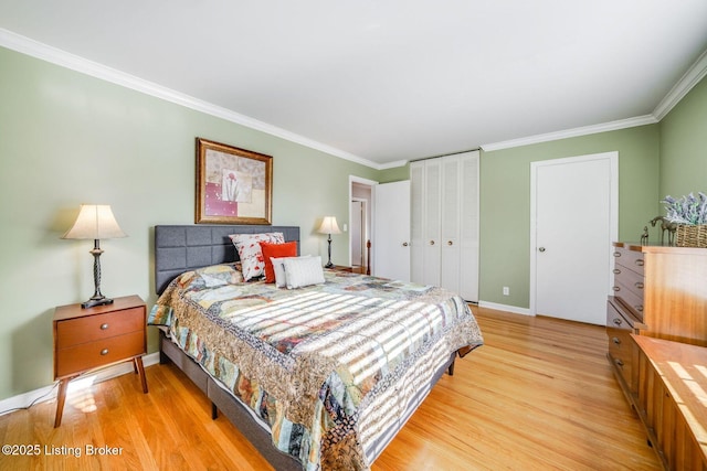 bedroom with crown molding, light wood-type flooring, and a closet