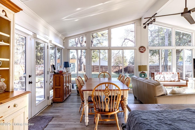 sunroom / solarium featuring a healthy amount of sunlight and vaulted ceiling