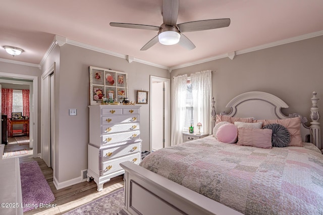 bedroom featuring hardwood / wood-style floors, ornamental molding, and ceiling fan