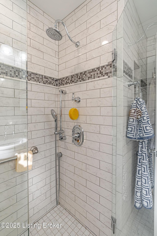 bathroom featuring a shower with shower door