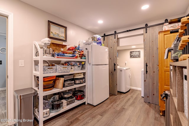 interior space featuring a barn door and hardwood / wood-style floors