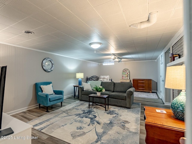 living room featuring hardwood / wood-style flooring and crown molding