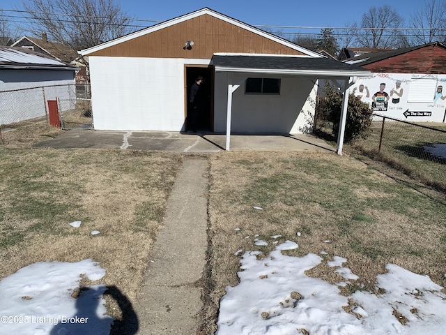 garage featuring a yard and a carport