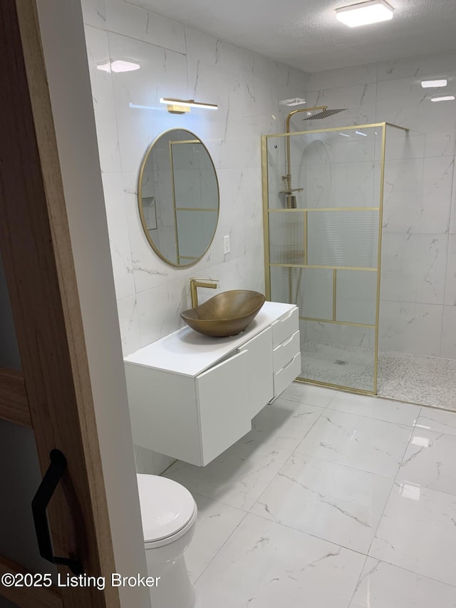 full bath featuring marble finish floor, toilet, vanity, and a marble finish shower