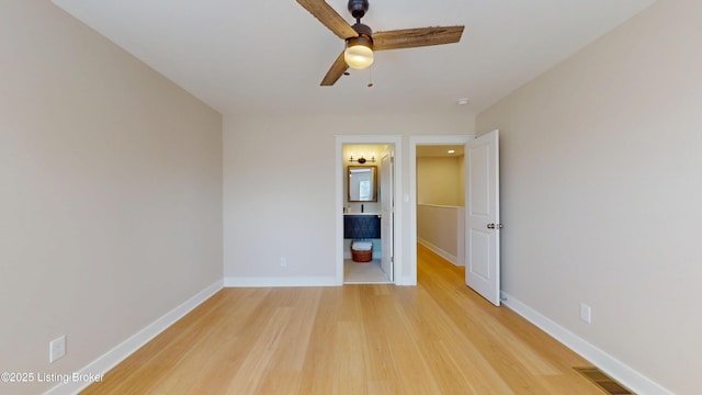 unfurnished bedroom with ceiling fan, connected bathroom, visible vents, baseboards, and light wood-style floors