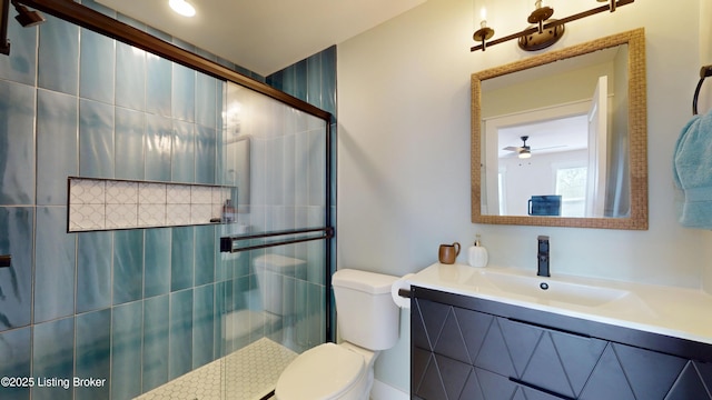 bathroom featuring toilet, a tile shower, and vanity