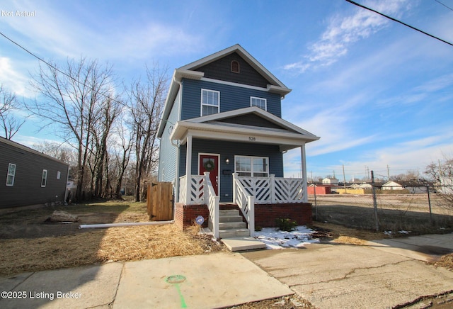 view of front of home featuring covered porch and fence