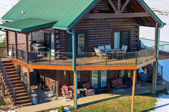 rear view of property featuring central AC, a patio area, and a deck