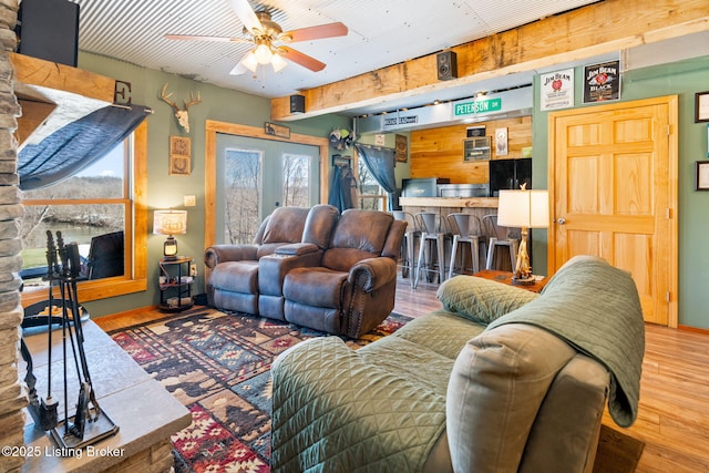 living room featuring hardwood / wood-style flooring, ceiling fan, and french doors