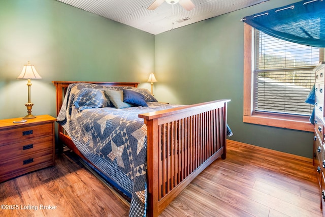 bedroom with wood-type flooring and ceiling fan