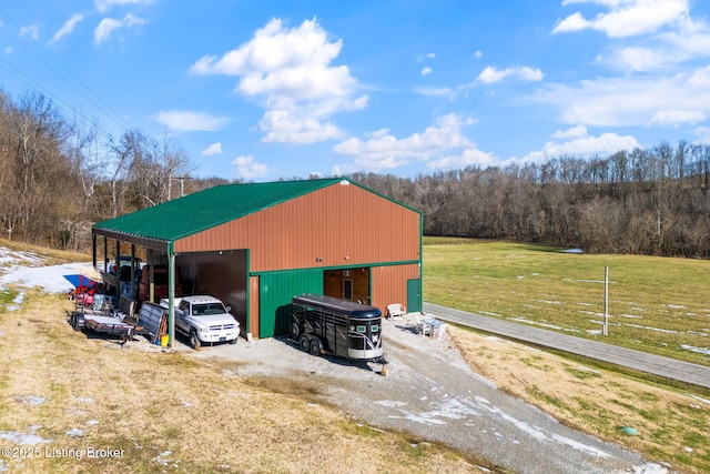 view of outbuilding featuring a carport and a yard