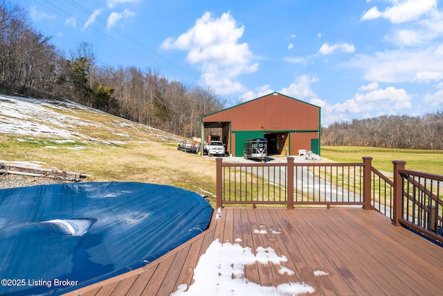 wooden deck with a carport and a yard