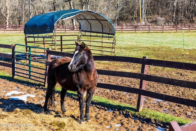 view of stable featuring a rural view