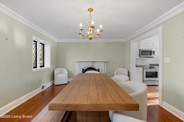 dining room with ornamental molding, dark hardwood / wood-style floors, and a chandelier