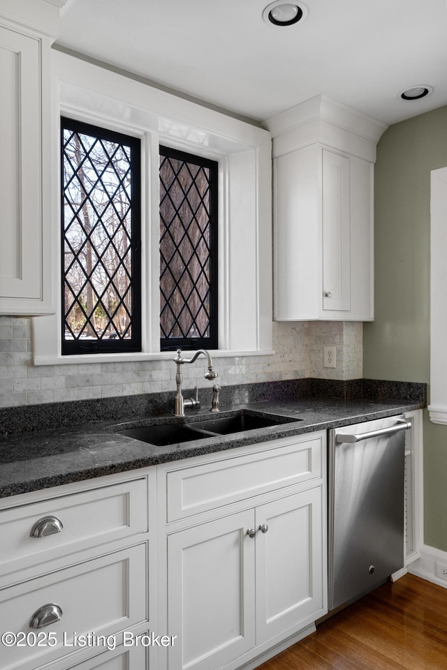 kitchen featuring white cabinetry, sink, decorative backsplash, and stainless steel dishwasher