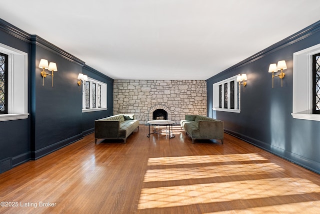 unfurnished living room with hardwood / wood-style floors and ornamental molding