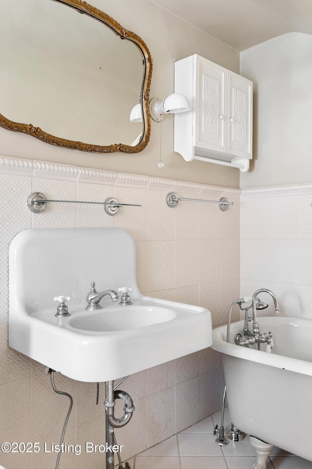 bathroom with tile walls, a bath, and tile patterned floors