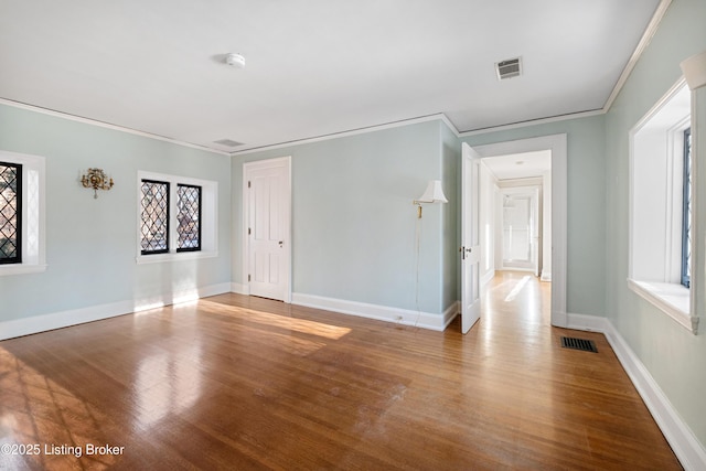 spare room with hardwood / wood-style flooring and ornamental molding