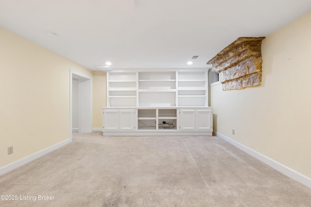 unfurnished living room with light colored carpet