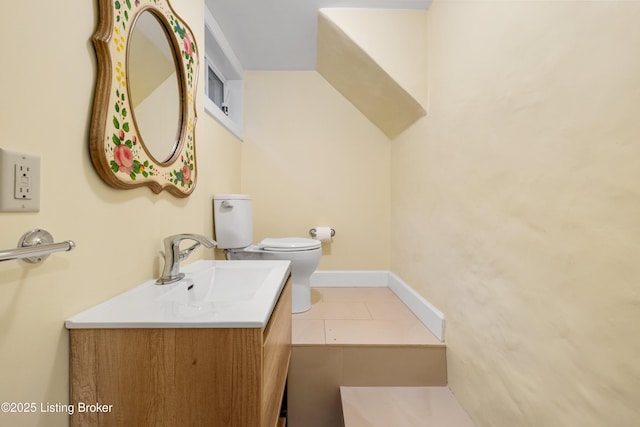 bathroom with vanity, tile patterned floors, and toilet