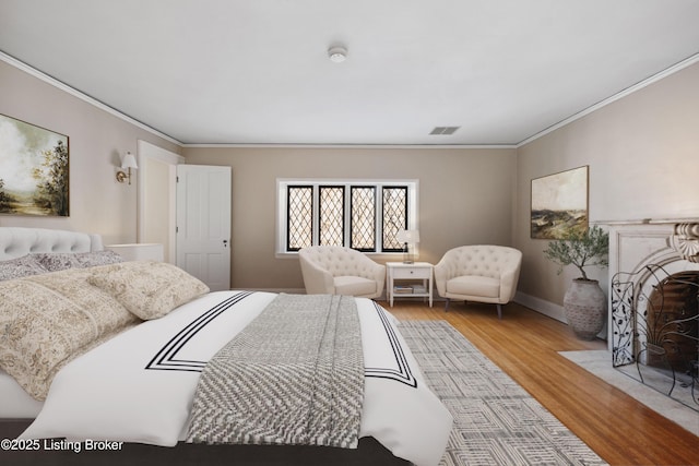 bedroom with hardwood / wood-style floors and crown molding